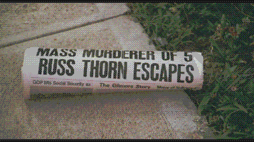 A newspaper headline reads &ldquo;Mass Murderer of 5 Russ Thorn Escapes, in a still from The Slumber Party Massacre.