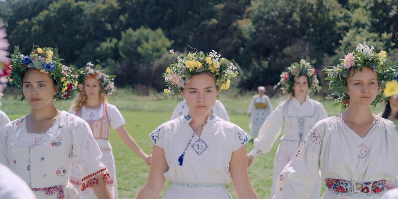 Girls dressed in white face the camera.