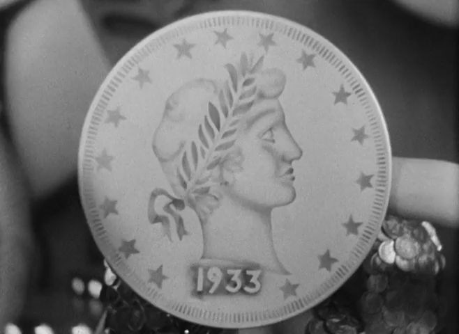 The first shot after the credits showing an oversized coin featuring a woman's profile
