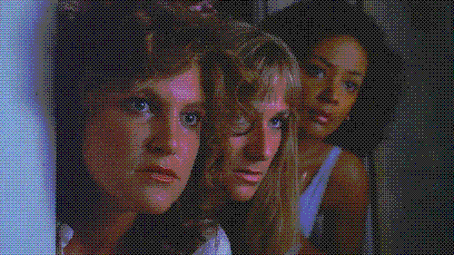 Three young women look around a door in a still from The Slumber Party Massacre.